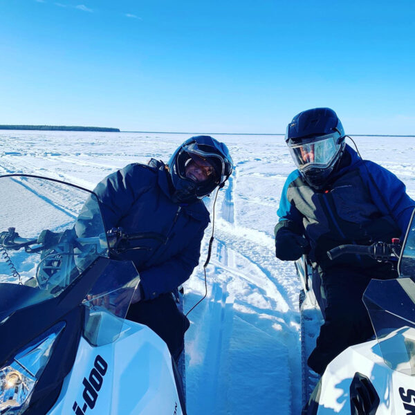 Two guys on snowmobiles at Gull Harbour